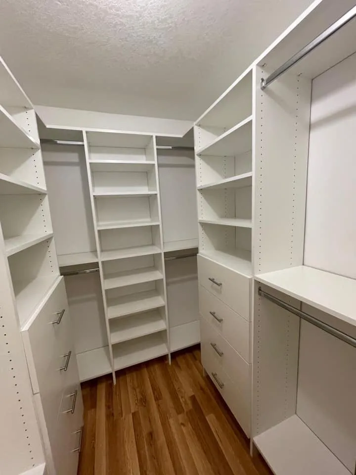 Custom reach-in closet with adjustable shelving and drawers after a luxury upgrade
